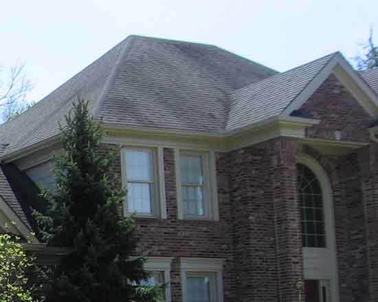 closer view of a house with a hip roof.